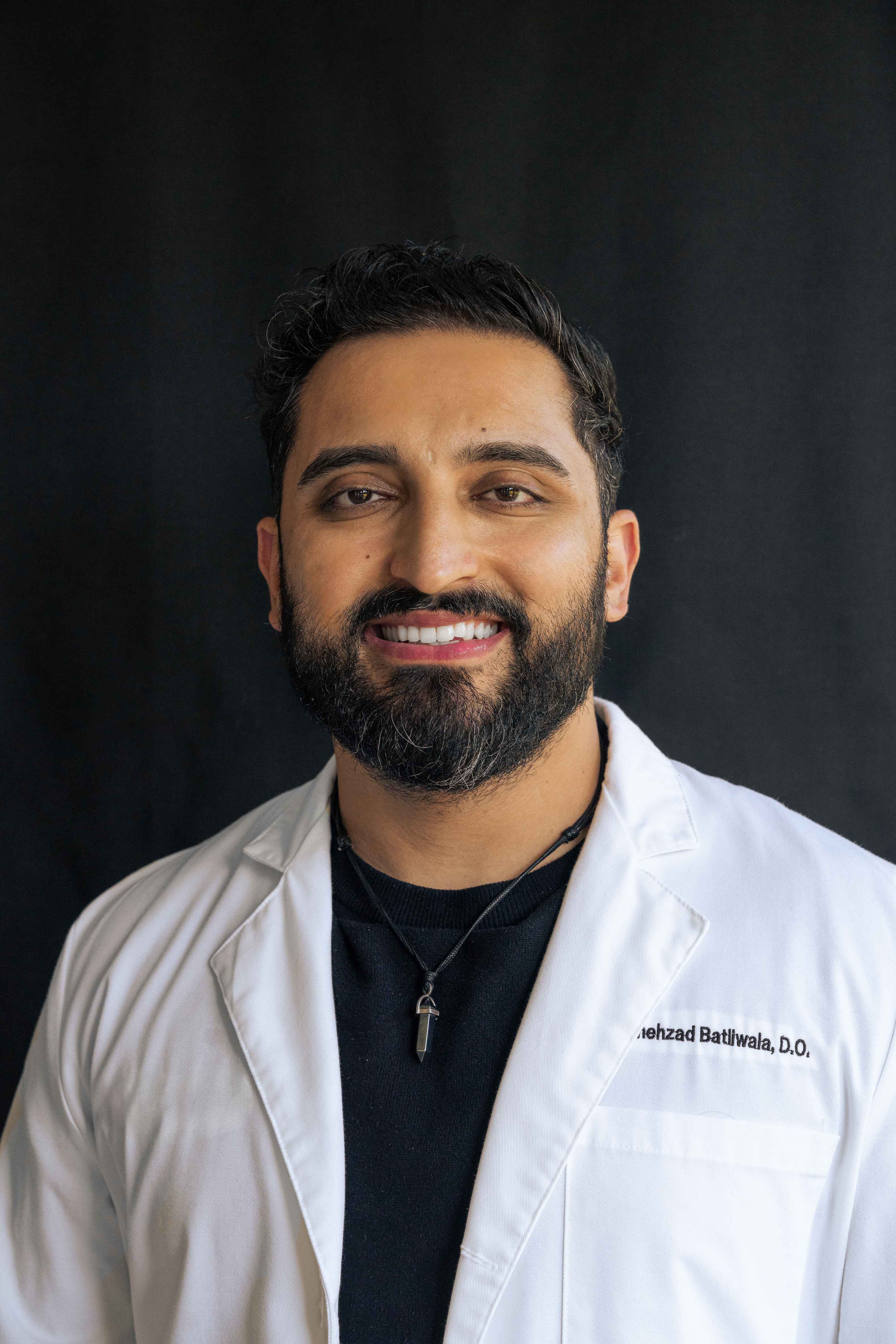 Dr. Shehzad Batliwala in a white coat